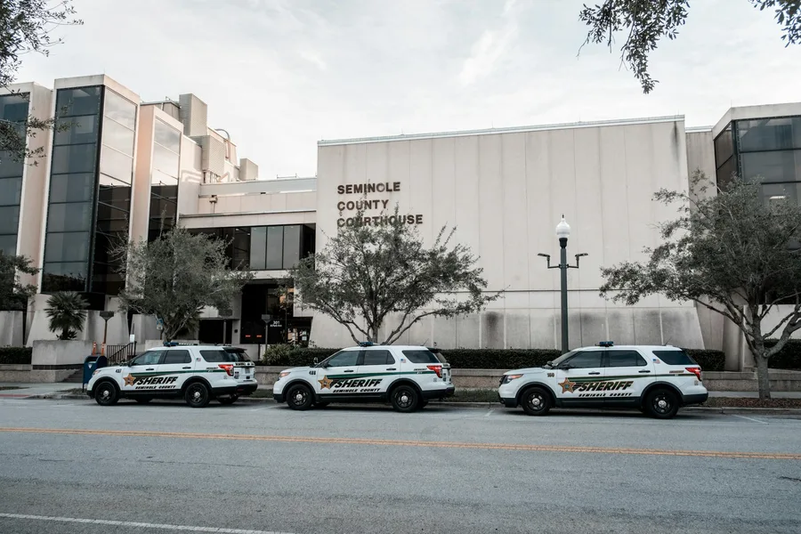 Sheriff vehicles parked in front of Seminole County Courthouse during the day.