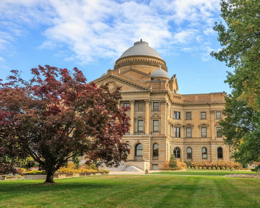 Elegant view of the Luzerne County Courthouse surrounded by autumn foliage under a clear blue sky.