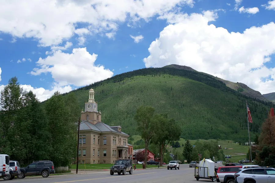 Scenic view of the San Juan County Courthouse with mountainous backdrop in Silverton, Colorado.