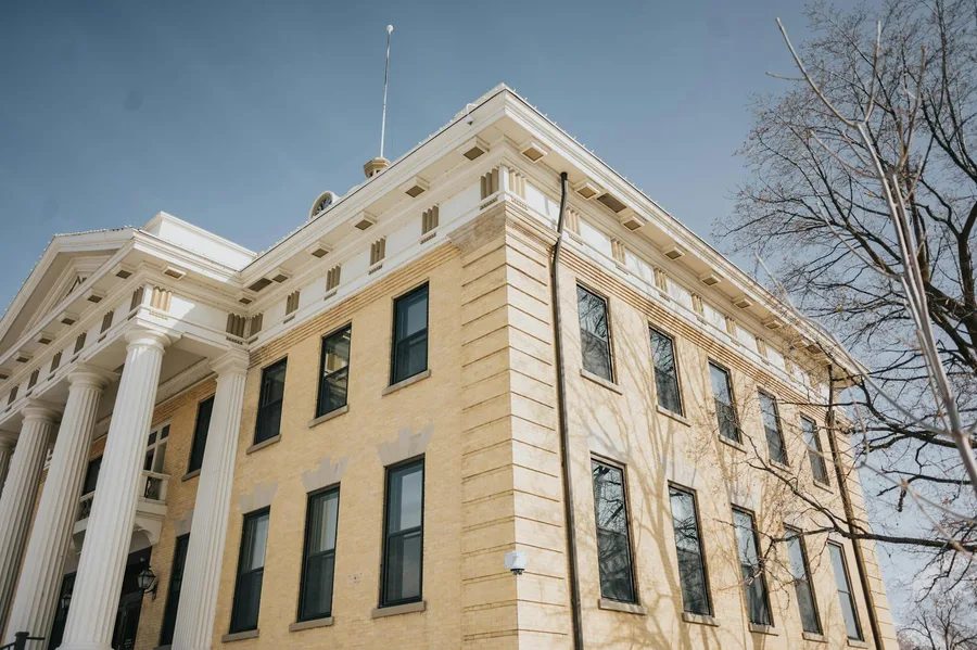Low angle view of the historic Box Elder County Courthouse with columns and blue sky, Brigham City, Utah.