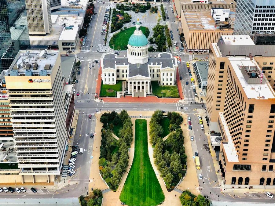 A stunning aerial view of the historic Old Courthouse in downtown St. Louis surrounded by city buildings.
