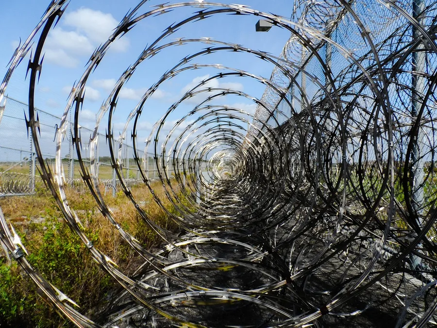 prison fence, razor ribbon, wire, metal, fence, barbed, barb, prison, spikes, barbwire, captive, captured, arrested, prisoner, inmate, detained, jail, protected, immokalee, florida, corrections, correctional institution, justice, law enforcement, police, prison, prison, prison, prison, prison, jail, jail