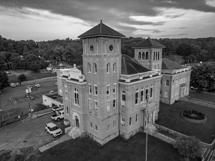 A stunning aerial view of a historic courthouse in black and white, showcasing classic architecture.