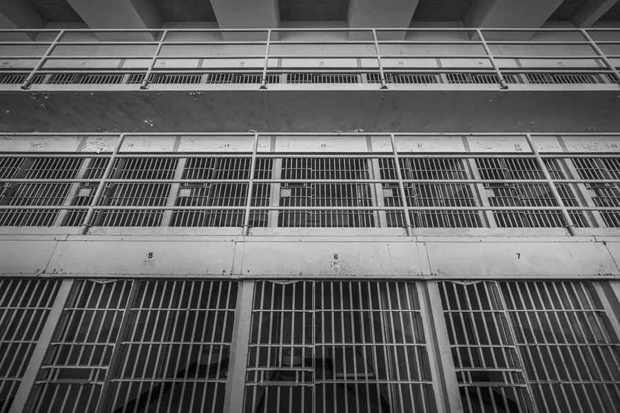 A haunting black and white view of prison cells inside Alcatraz, showcasing its storied history.