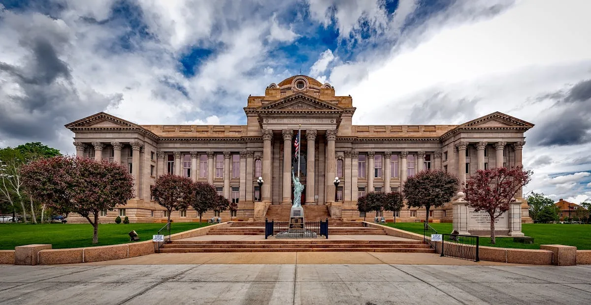 Front view of a neoclassical courthouse building in Colorado with lush greenery.
