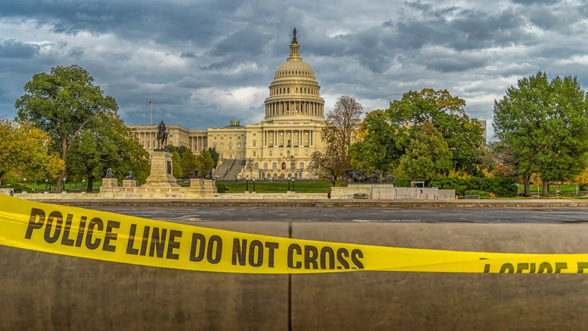 View of US Capitol Building behind police tape under a cloudy sky in Washington, DC.