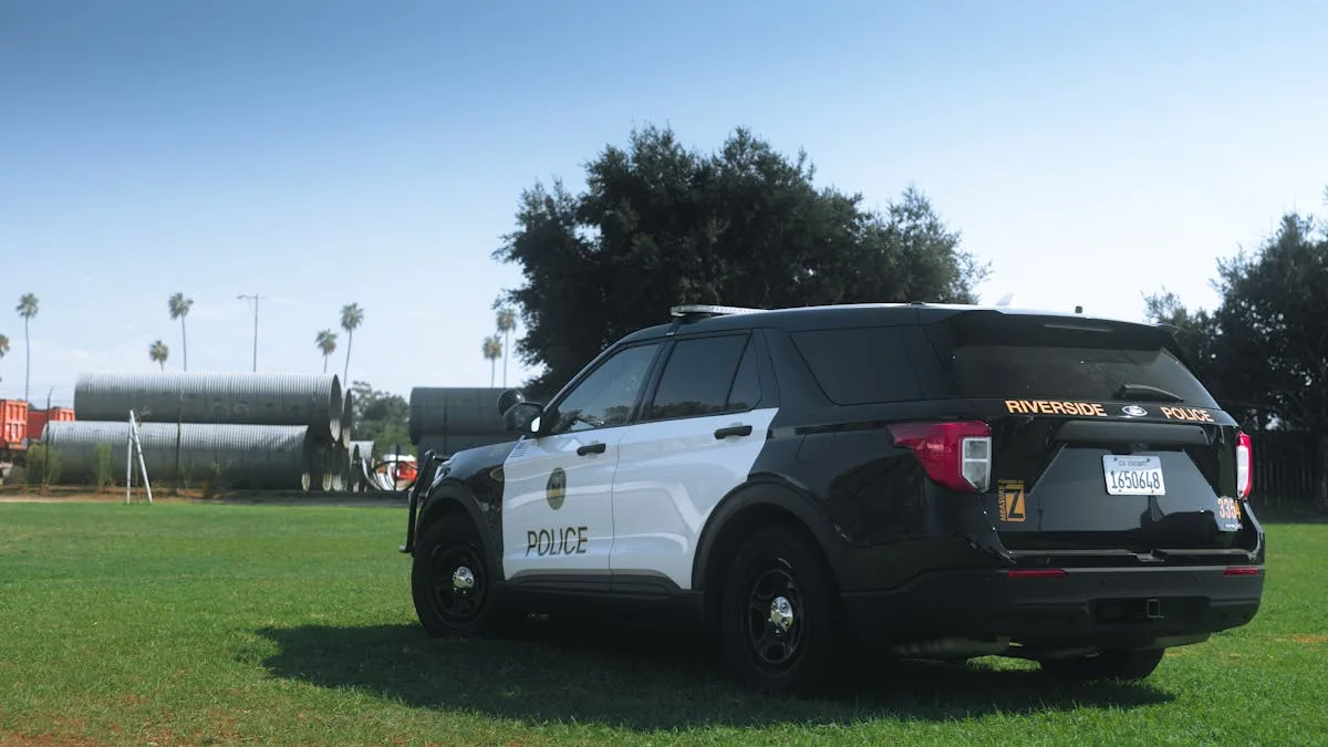Black and white Riverside Police SUV parked in a sunny grassy area.
