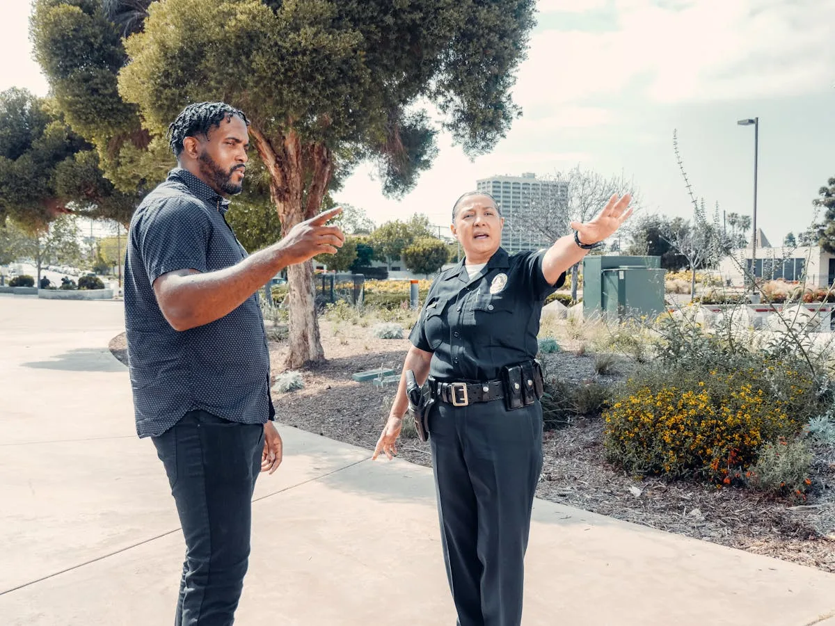 Police officer speaking with a man outdoors, showcasing community engagement.